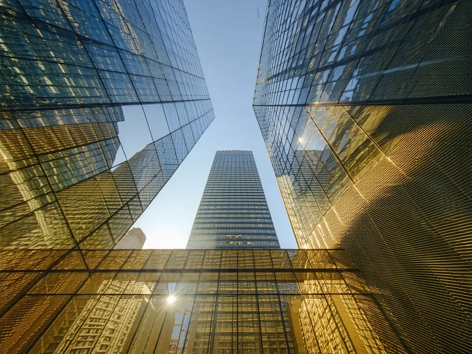 Downtown Manhattan financial district skyline viewed from lower Broadway, representing Aark's New York roots in financial infrastructure
